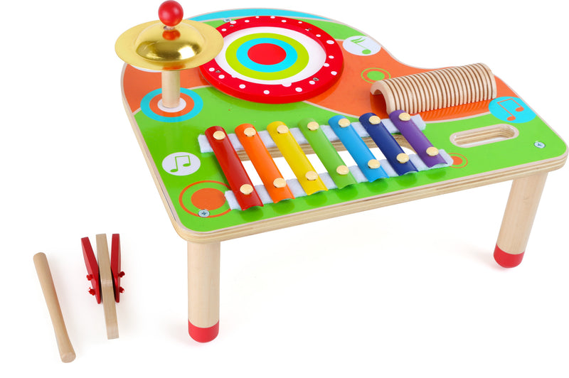 Farverigt musikbord i træ med flere forskelige instrumenter fra Small Foot