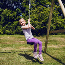 En pige sidder og gynger på den sorte tallerkengynge fra Nordic Play  