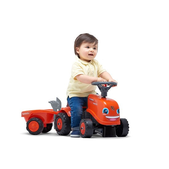 et barn der leger på Bayb Kubota traktor fra Falk
