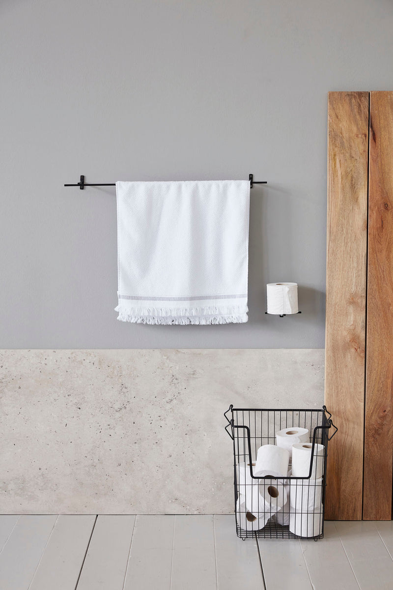 Den metalliske toiletpapirsholder Add fra House Doctor hænger på en væg